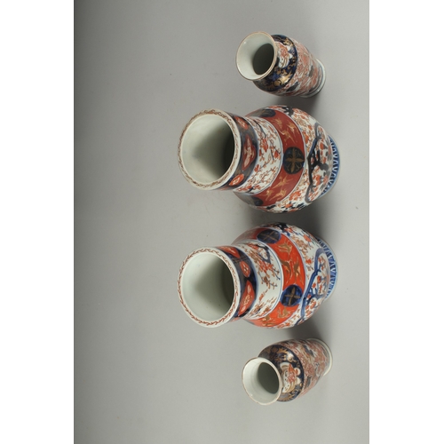 95 - A PAIR OF JAPANESE IMARI PORCELAIN VASES, together with a pair of smaller vases, larger pair 22cm hi... 