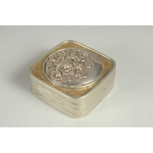 97 - A SMALL SIGNED JAPANESE WHITE METAL AND BRASS BOX, the hinged lid with relief dragon roundel, 5cm sq... 