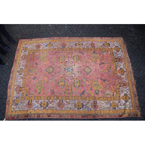 1004 - A LARGE AFGHAN CARPET  rust ground with stylised decoration 13ft 6ins x 10ft 4ins.