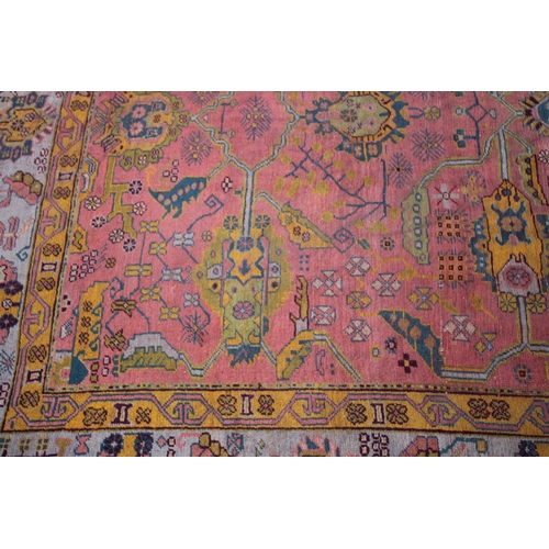 1004 - A LARGE AFGHAN CARPET  rust ground with stylised decoration 13ft 6ins x 10ft 4ins.