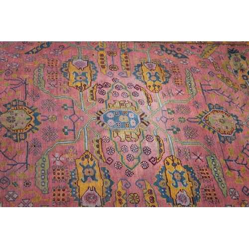 1004 - A LARGE AFGHAN CARPET  rust ground with stylised decoration 13ft 6ins x 10ft 4ins.