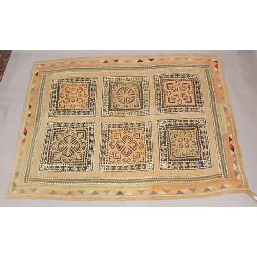 1007 - A QUILTED BEDSPREAD cream ground with six square panels of geometric designs. 7ft 5ins x 4ft 8ins.... 