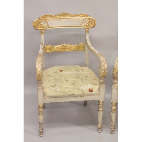 1023 - A GOOD PAIR OF REGENCY CREAM PAINTED AND GILDED ARM CHAIRS with accanthus curving drop in padded sea... 