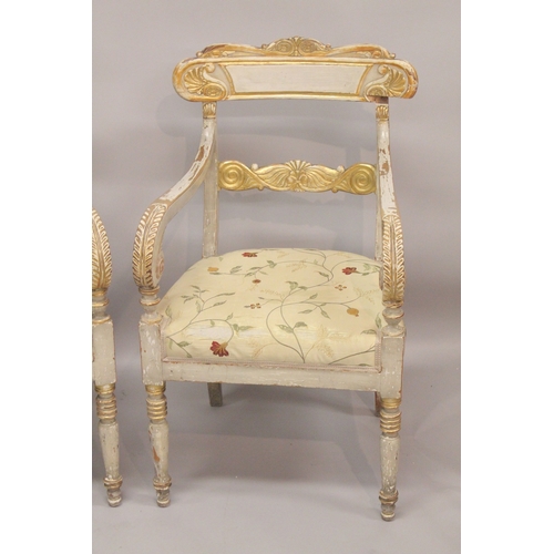 1023 - A GOOD PAIR OF REGENCY CREAM PAINTED AND GILDED ARM CHAIRS with accanthus curving drop in padded sea... 