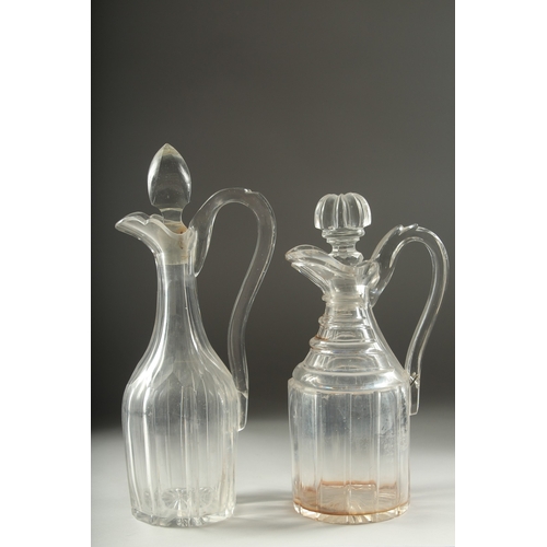 1048 - TWO HEAVY CUT GLASS CLARET JUGS AND STOPPERS.