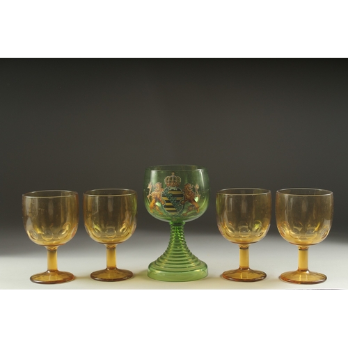 1049 - A LARGE ARMORIAL GREEN GOBLET, 8ins high and four plain amber goblets (5).