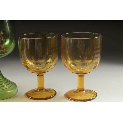 1049 - A LARGE ARMORIAL GREEN GOBLET, 8ins high and four plain amber goblets (5).