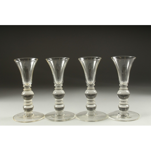 1050B - A SET OF FOUR PLAIN KNOP STEM WINE GLASSES. 7ins high.