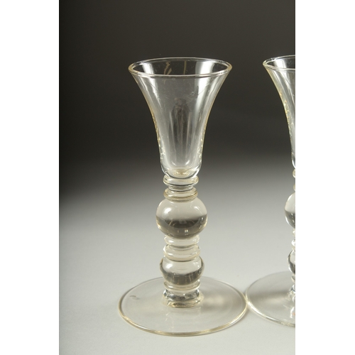 1050B - A SET OF FOUR PLAIN KNOP STEM WINE GLASSES. 7ins high.