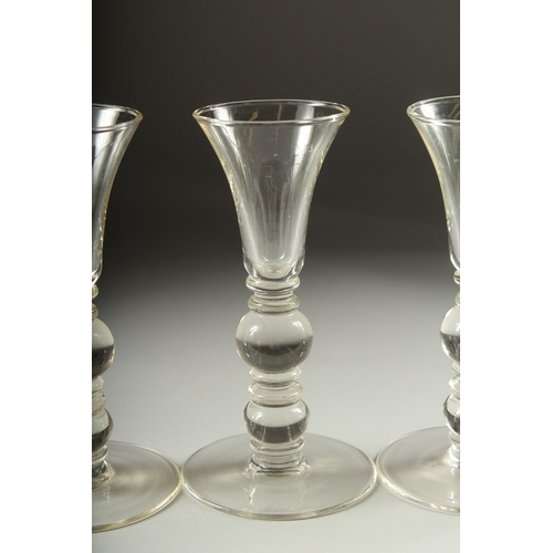 1050B - A SET OF FOUR PLAIN KNOP STEM WINE GLASSES. 7ins high.