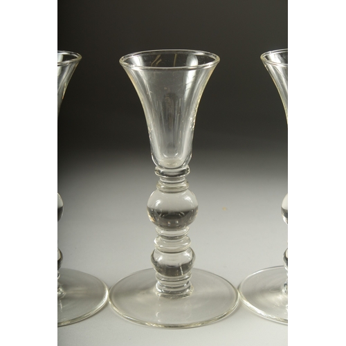 1050B - A SET OF FOUR PLAIN KNOP STEM WINE GLASSES. 7ins high.