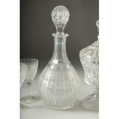 1050C - A GOOD CUT GLASS SHERRY DECANTER AND STOPPER, SIX GLASSES AND BOWL AND COVER.(8).