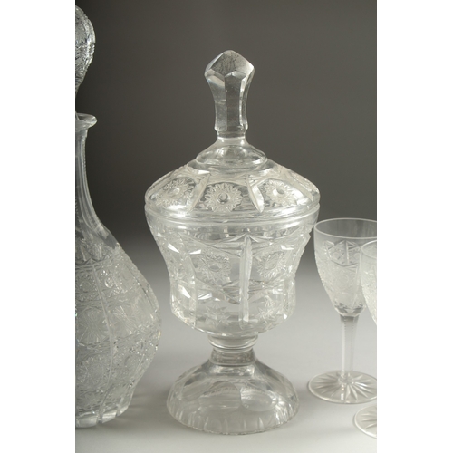 1050C - A GOOD CUT GLASS SHERRY DECANTER AND STOPPER, SIX GLASSES AND BOWL AND COVER.(8).