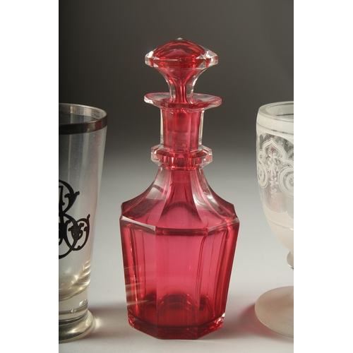 1050D - A SMALL RUBY DECANTER AND STOPPER, silver overlay beaker, a knop beaker and a blue and white beaker ... 