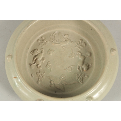 1077 - A Chinese celadon glazed moulded circular brush washer.