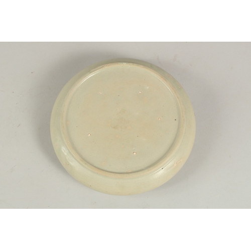 1077 - A Chinese celadon glazed moulded circular brush washer.