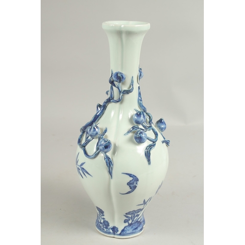 1082 - A CHINESE BLUE AND WHITE PEACH VASE with peaches in  relief, square blue mark.  12ins high.