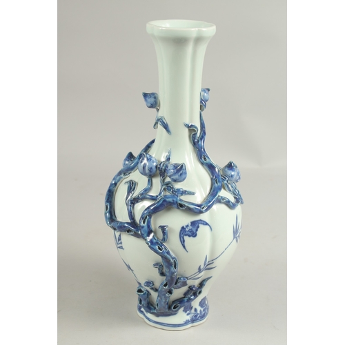 1082 - A CHINESE BLUE AND WHITE PEACH VASE with peaches in  relief, square blue mark.  12ins high.