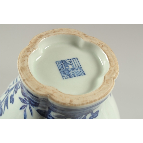 1082 - A CHINESE BLUE AND WHITE PEACH VASE with peaches in  relief, square blue mark.  12ins high.