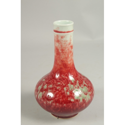 1084 - A CHINESE SPLASH RED BOTTLE VASE, six character mark.  7ins high.