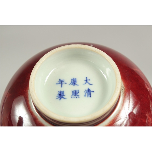 1084 - A CHINESE SPLASH RED BOTTLE VASE, six character mark.  7ins high.