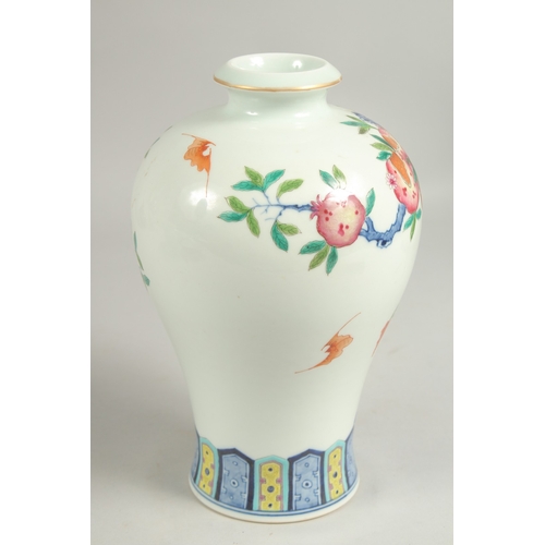 1085 - A CHINESE VASE PAINTED WITH FLOWERING TREES DESIGN. Six character mark.  8.5ins high.