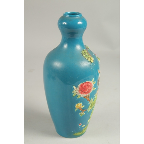 1089 - A CHINESE BLUE VASE with a stork in relief, impressed mark.  8ins high.