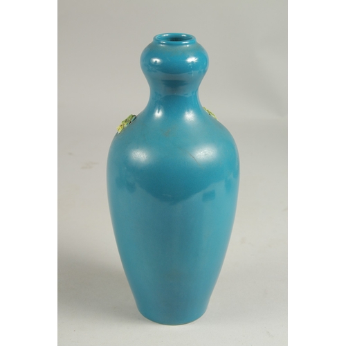 1089 - A CHINESE BLUE VASE with a stork in relief, impressed mark.  8ins high.