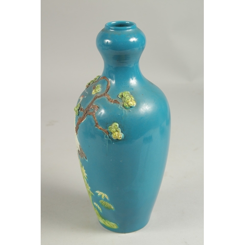 1089 - A CHINESE BLUE VASE with a stork in relief, impressed mark.  8ins high.