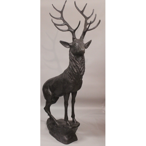 1109 - AFTER JULES MOIGNIEZ. A GOOD MASSIVE PAIR OF BRONZE STAGS on rocky bases. 6ft 3ins high.