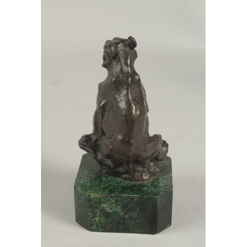 1116 - A SMALL BRONZE SEATED BEAR on a metal base.  5ins.