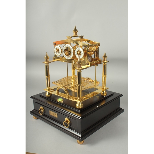 1122 - A GOOD ROLLING BALL CLOCK with three dials in a glass case. 16ins high overall.