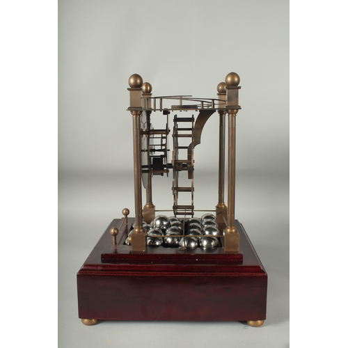 1124 - A ROLLING BALL CLOCK with 21 large chrome balls, in a glass case.