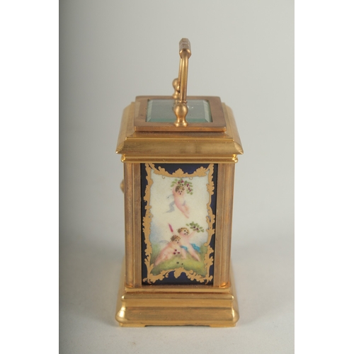 1130 - A MINIATURE CARRIAGE CLOCK with Sevres panel. 8cm high.