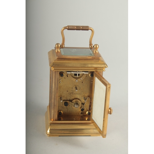 1130 - A MINIATURE CARRIAGE CLOCK with Sevres panel. 8cm high.