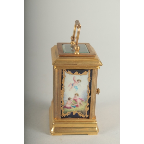 1130 - A MINIATURE CARRIAGE CLOCK with Sevres panel. 8cm high.