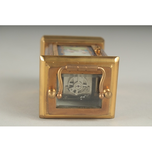 1130 - A MINIATURE CARRIAGE CLOCK with Sevres panel. 8cm high.