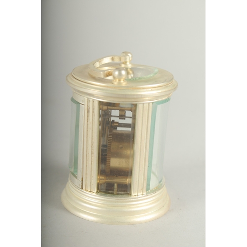 1131 - A SMALL ROUND SILVER CARRIAGE CLOCK. 7cm high.