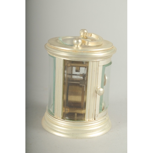 1131 - A SMALL ROUND SILVER CARRIAGE CLOCK. 7cm high.