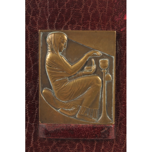 1149 - A PAIR OF ART NOUVEAU CAST BRONZE RELIEFS on leather strut frames. 2.75ins x 2.25ins.