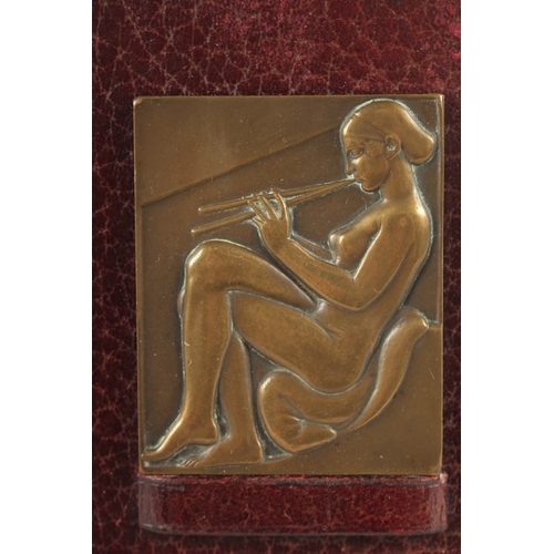 1149 - A PAIR OF ART NOUVEAU CAST BRONZE RELIEFS on leather strut frames. 2.75ins x 2.25ins.