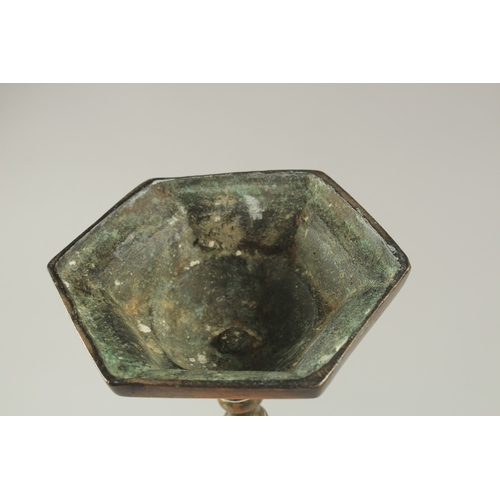 1157 - A CLASSICAL BRONZE HEXAGONAL CANDLESTICK. 15.5ins high.