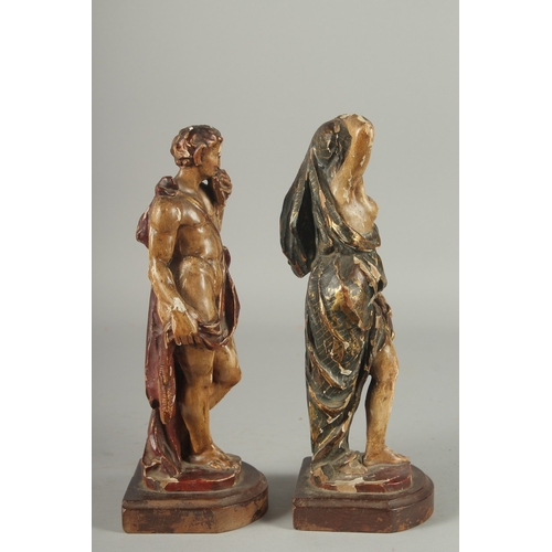 1165 - A GOOD PAIR OF 17TH - 18TH CENTURY CARVED AND POLYCHROMED WOOD FIGURES. A man playing a pan pipe and... 