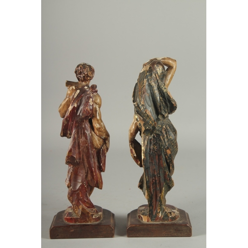 1165 - A GOOD PAIR OF 17TH - 18TH CENTURY CARVED AND POLYCHROMED WOOD FIGURES. A man playing a pan pipe and... 