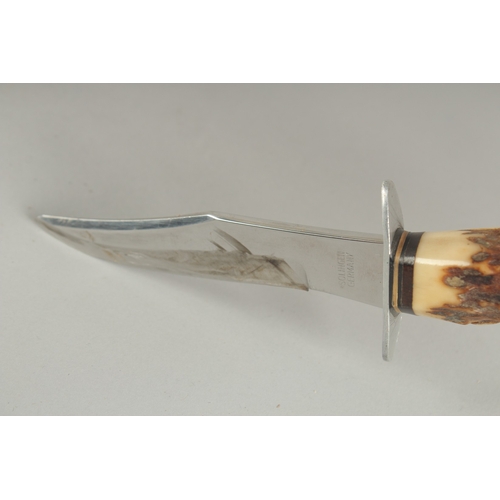 1178 - A SOLINGER GERMAN KNIFE with 4.5ins blade and bone handle, in a leather sheath.