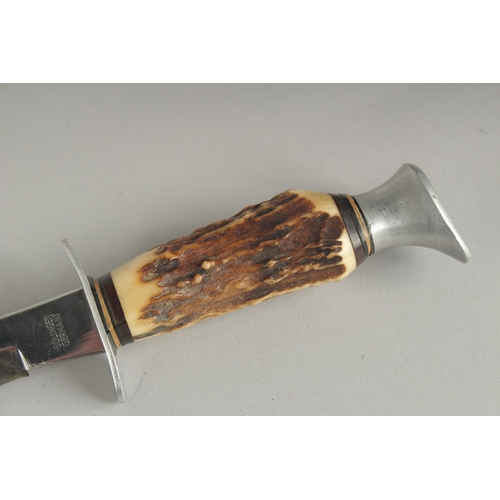 1178 - A SOLINGER GERMAN KNIFE with 4.5ins blade and bone handle, in a leather sheath.