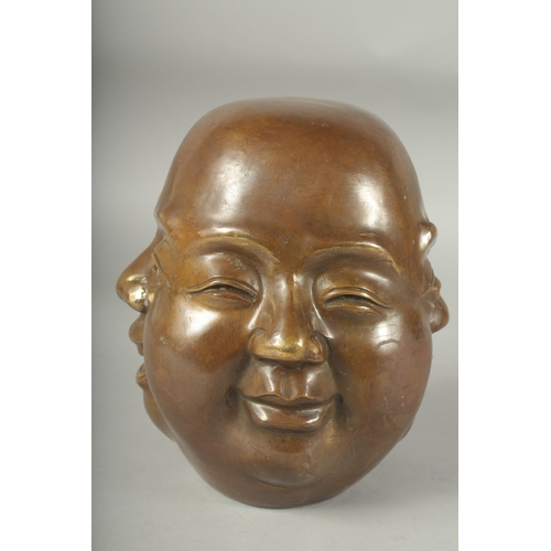 1196 - A BRONZE FOUR FACED BUDDHA. 8ins high.