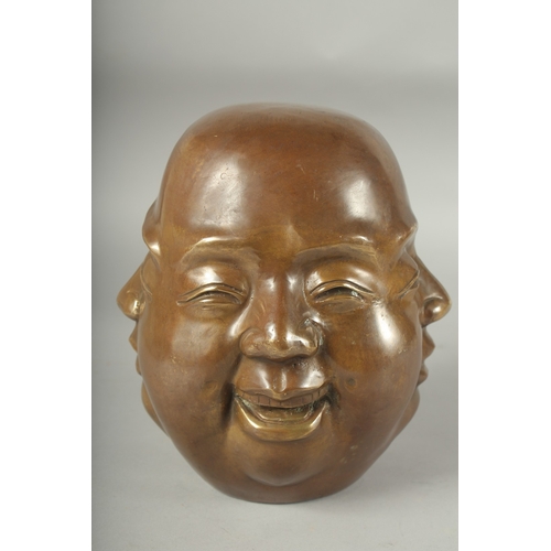 1196 - A BRONZE FOUR FACED BUDDHA. 8ins high.