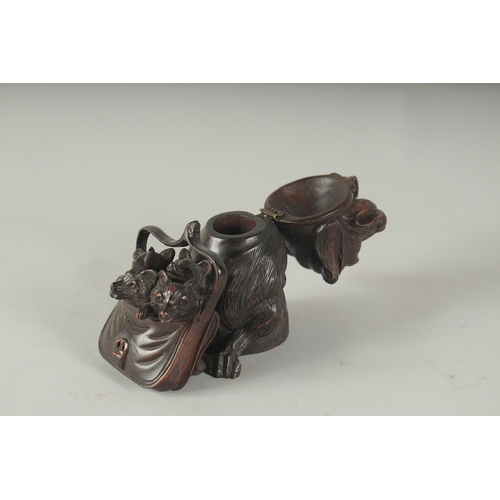 1225 - A BLACK FOREST CARVED WOOD DOG carrying three puppies in a basket, formed as an inkwell. 4.5ins high... 