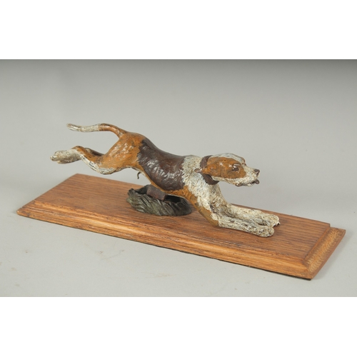 1227 - AN AUSTRIAN COLD PAINTED BRONZE SPORTING DOG LETTER CLIP on a wooden base.  8ins long.